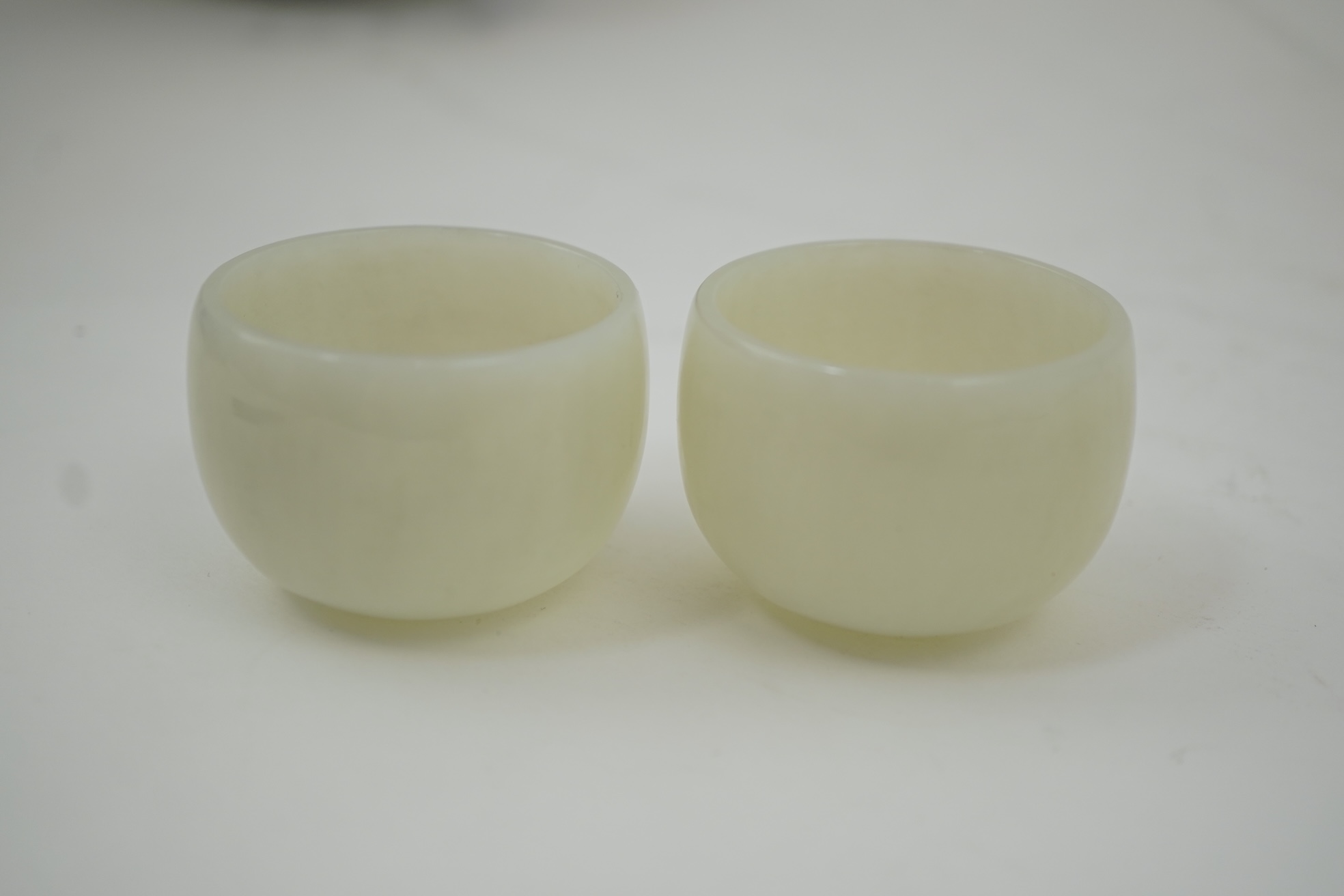 A pair of Chinese white jade cups, Qing dynasty or later